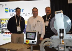 Kevin Guadagnini, Chris Faxon and Mark Reed with Sinclair International stand behind a pattern labeling machine.
